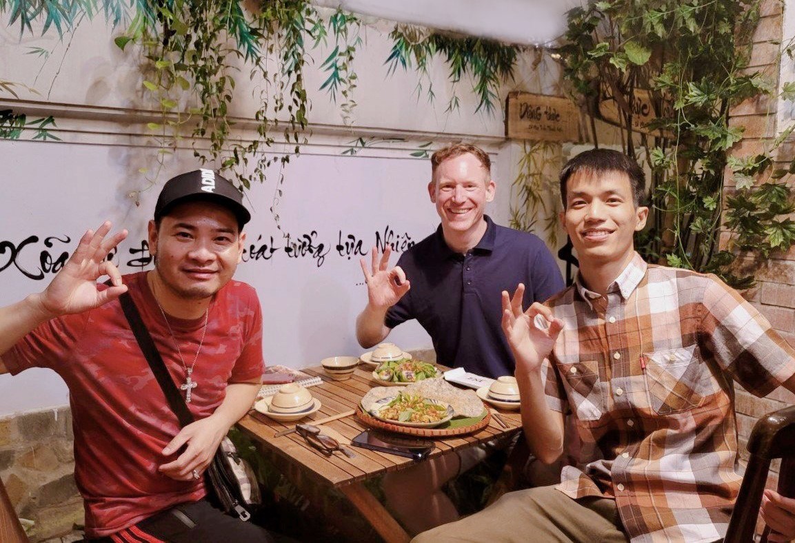 Foreign travelers enjoying a peaceful vegetarian meal in a cozy restaurant atmosphere