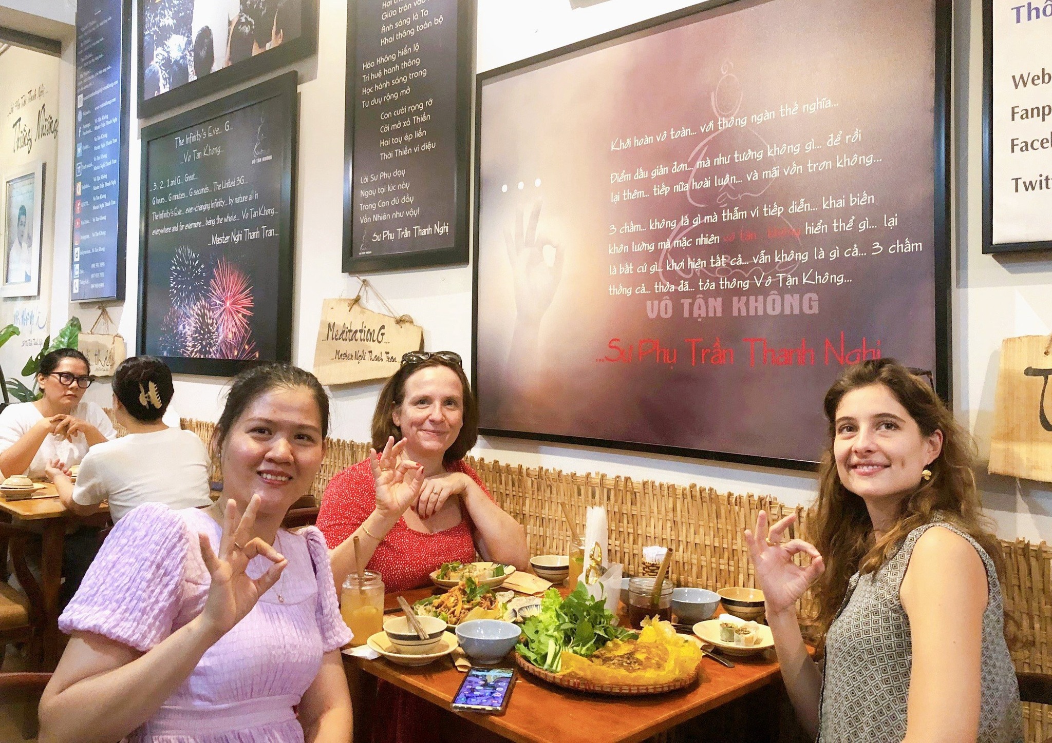 International diners smiling and enjoying traditional vegan Vietnamese food together