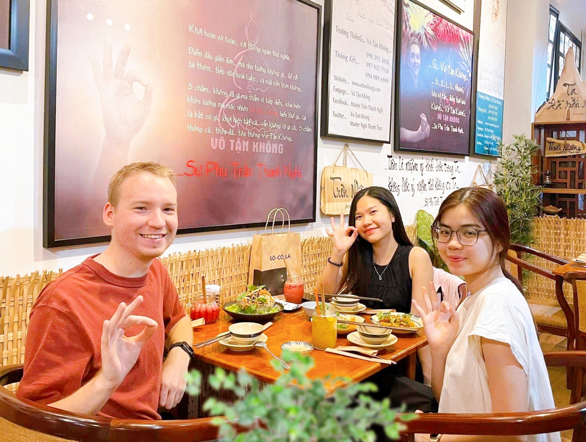 Tourists experiencing traditional Vietnamese vegan food with delight at Phương Mai restaurant
