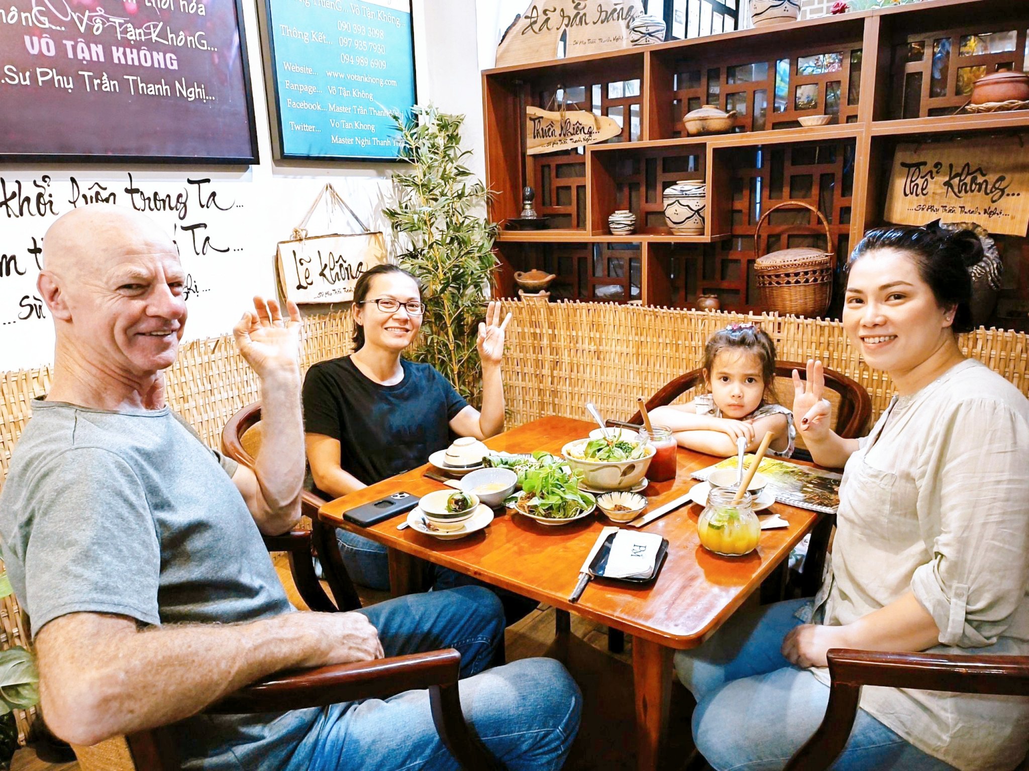 Tourists enjoying fresh and flavorful Vietnamese vegetarian dishes in a cozy restaurant setting