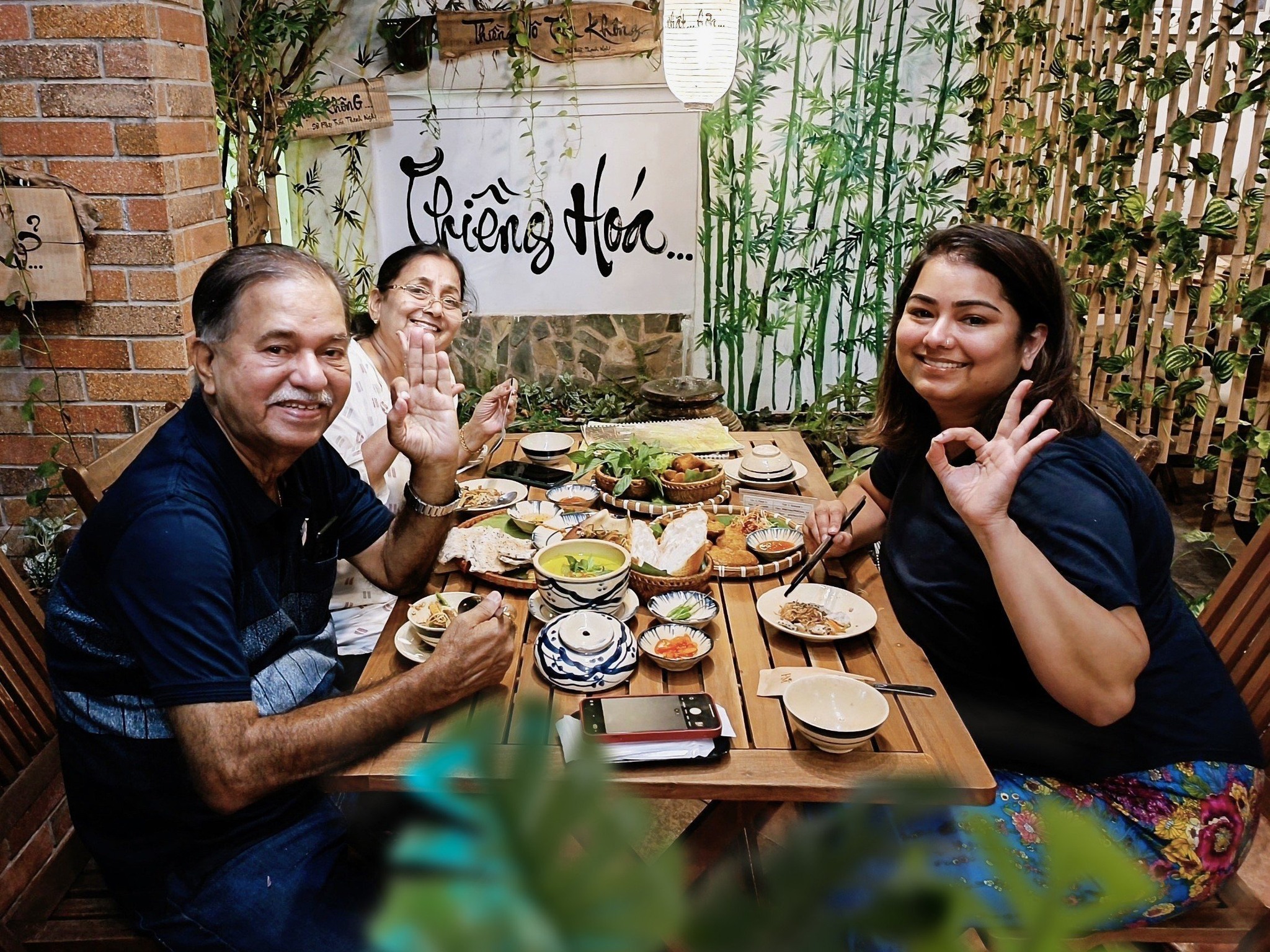 International Visitors Sharing a Vegetarian Meal at Phương Mai Happy foreign diners relaxing inside Nhà hàng chay Phương Mai vegetarian restaurant