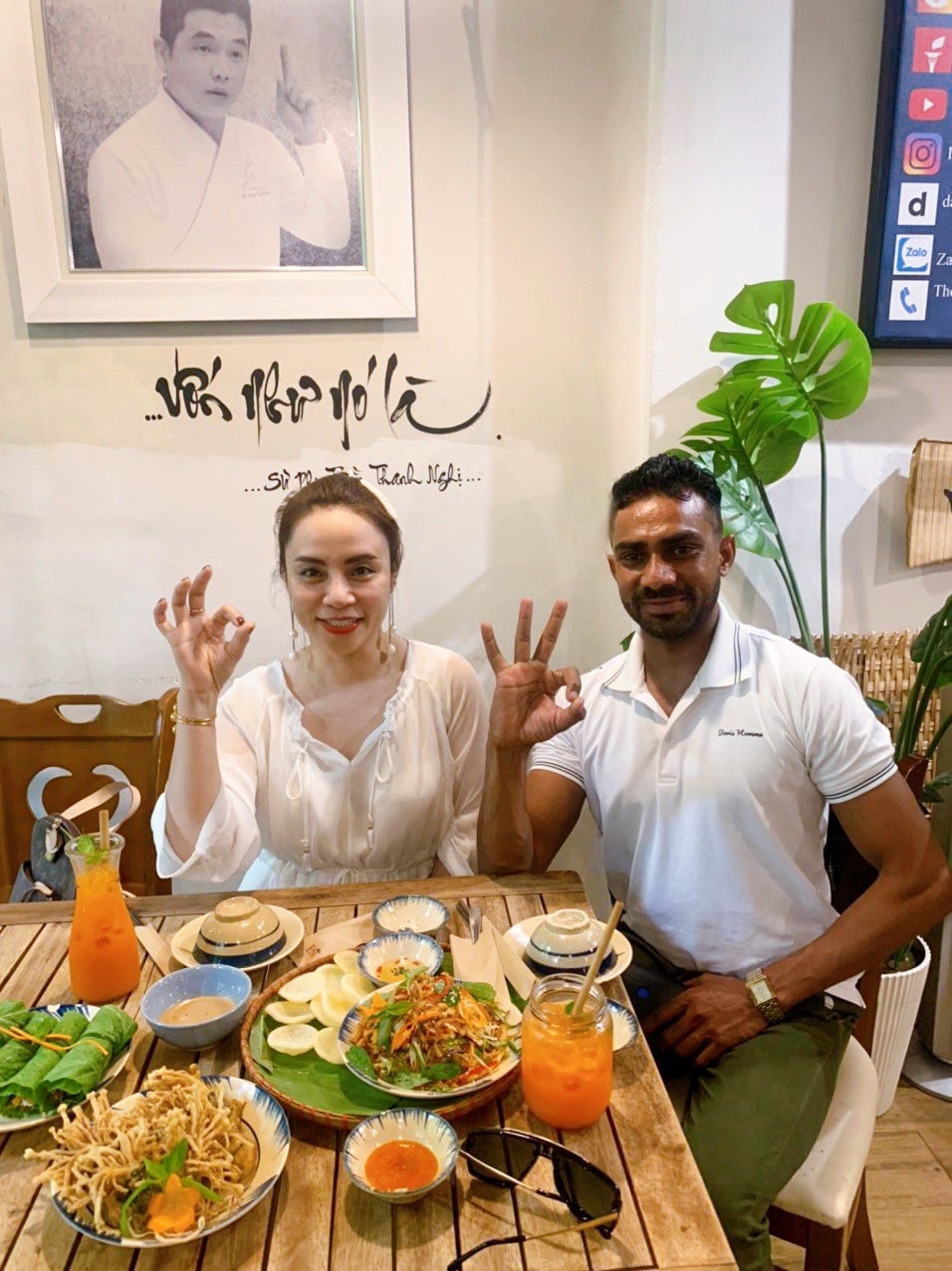 Foreign travelers smiling while dining at a hidden vegetarian restaurant in District 1 Saigon