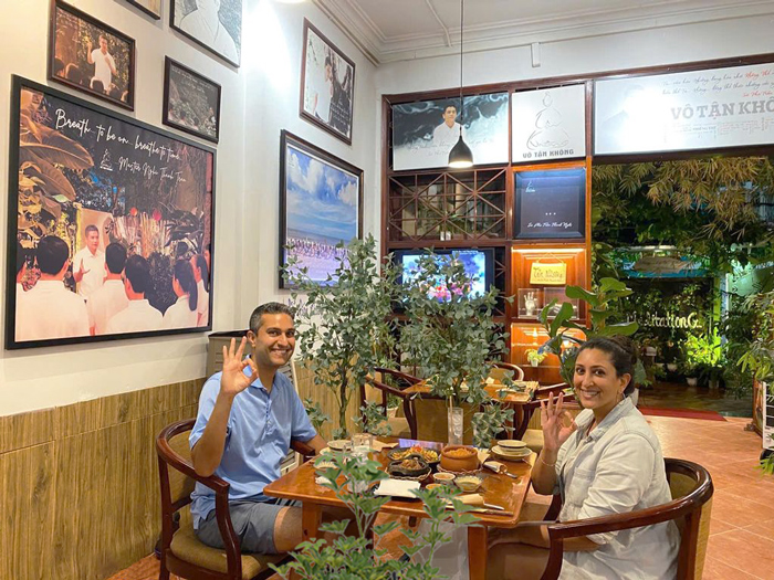 Foreign diners enjoying a relaxed vegetarian dining moment.