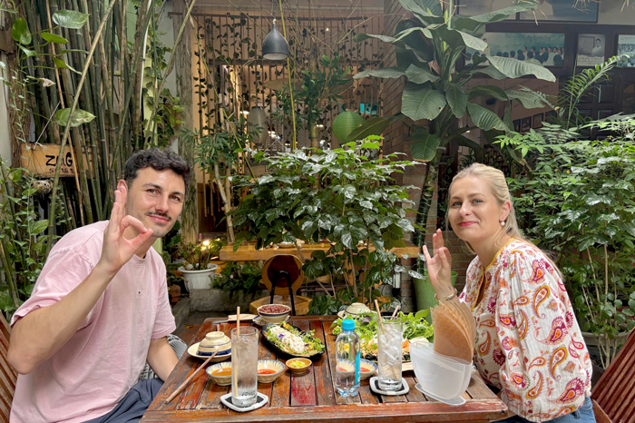 International travelers enjoying vegetarian cuisine at Phuong Mai.