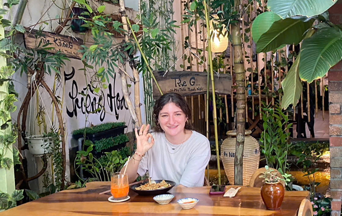 Happy international guests showing approval after a vegetarian meal at Phuong Mai in Saigon.