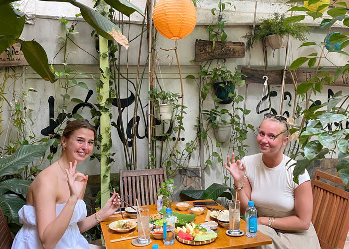 Western travelers enjoying fresh vegan lunch Saigon