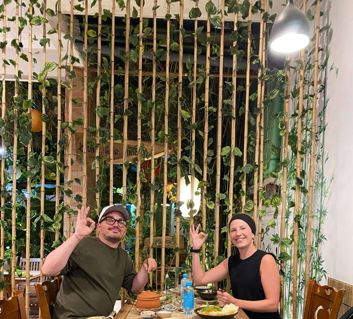 Foreign visitors enjoying calm vegan restaurant atmosphere
