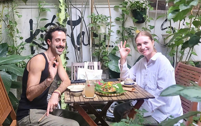 Tourists experiencing vegetarian Vietnamese cuisine in Ho Chi Minh City.