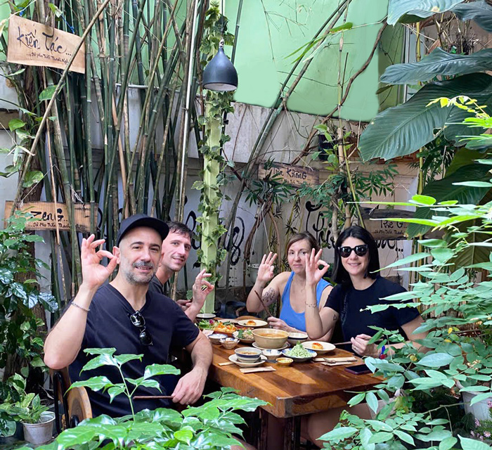 Happy international guests at a vegetarian restaurant in central Saigon.