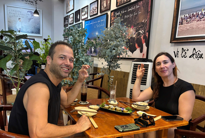 International tourists enjoying Vietnamese vegetarian food at a local restaurant.