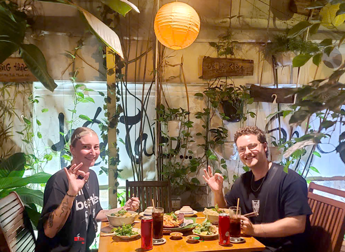 International visitors enjoying healthy vegan meals at Phuong Mai