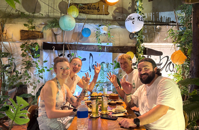 Tourists enjoying plant-based Vietnamese cuisine