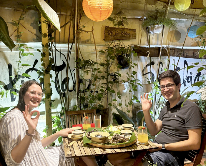 Tourists eating vegetarian food at a popular restaurant in Saigon.