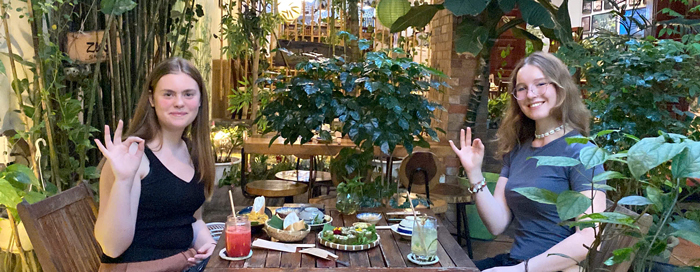 Travelers taking photos at plant based restaurant District 1