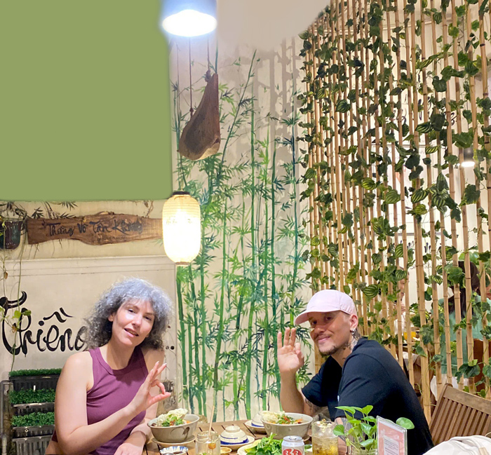 International visitors taking photos at vegan restaurant Saigon