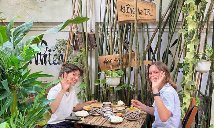 Tourists taking selfies inside vegetarian restaurant Ho Chi Minh City