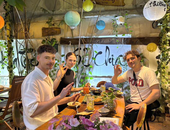 Foreign customers posing at vegetarian restaurant District 1