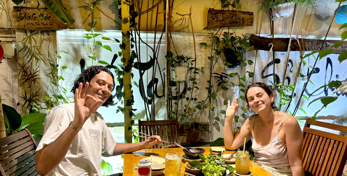 Tourists taking group photo inside vegetarian restaurant District 1