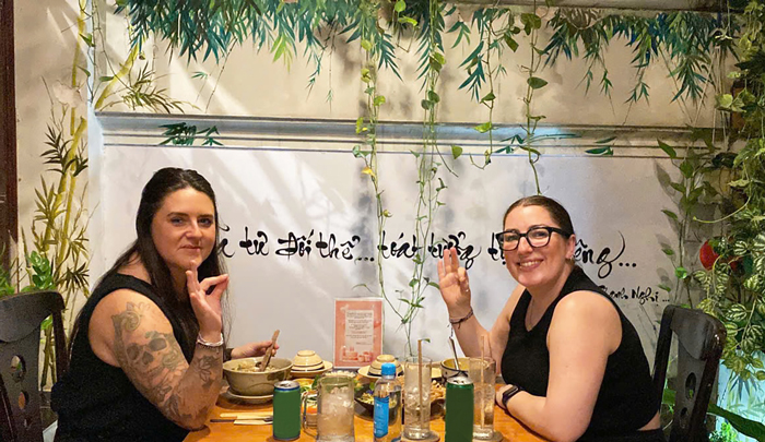 International visitors enjoying vegetarian Vietnamese food in Saigon.