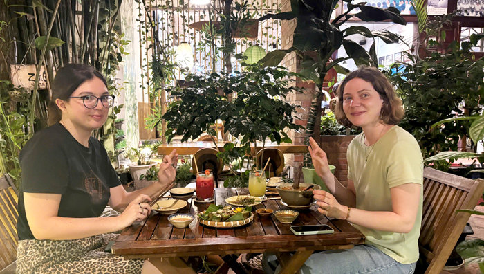International guests enjoying relaxed vegan meals