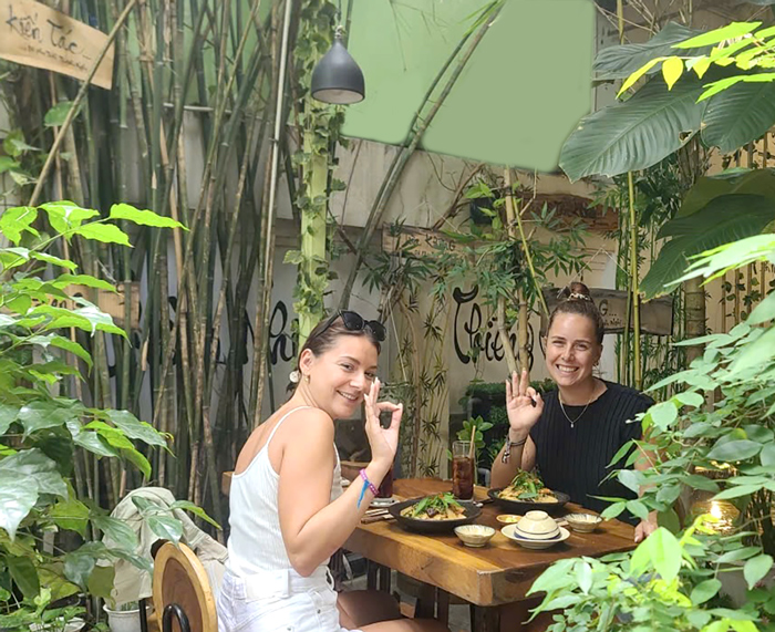International diners experiencing vegetarian Vietnamese cuisine in Ho Chi Minh City.