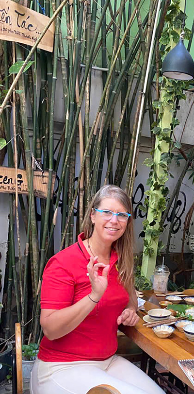 Foreign travelers enjoying vegetarian food in a friendly Saigon restaurant.