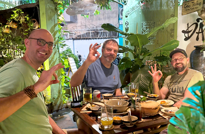 International visitors relaxing while dining at a vegetarian restaurant in Saigon.