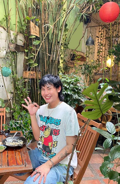 International travelers smiling after a vegetarian meal in Ho Chi Minh City.