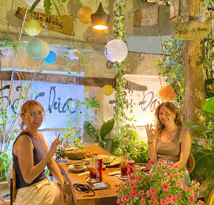 Western friends enjoying dinner at vegan restaurant Saigon