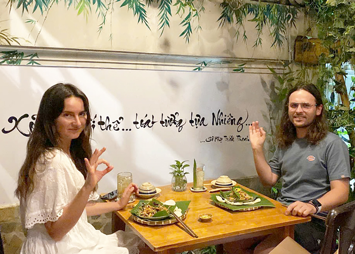 Tourists enjoying a vegetarian dining experience in the heart of Saigon.