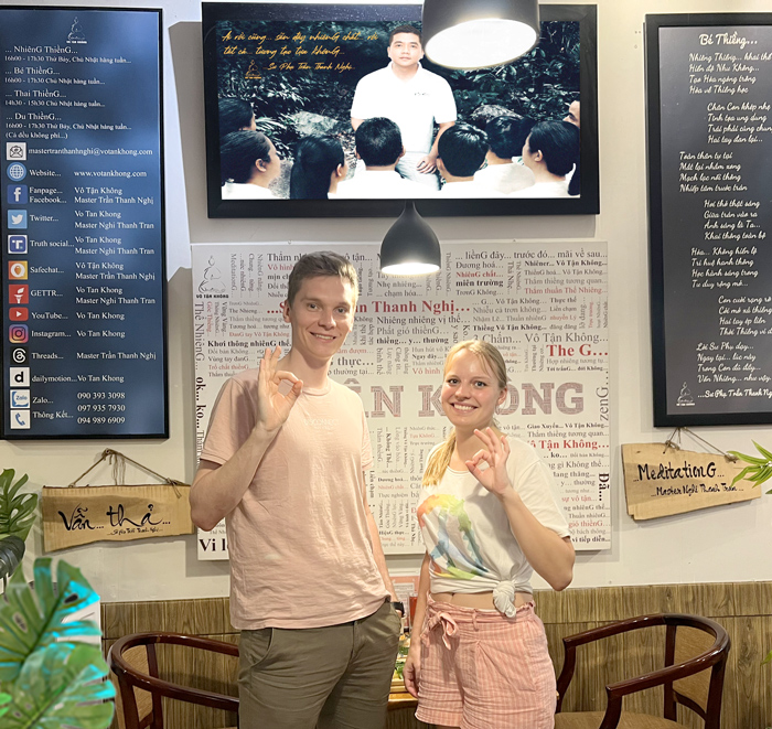 Happy foreign travelers dining at best vegetarian restaurant in Saigon