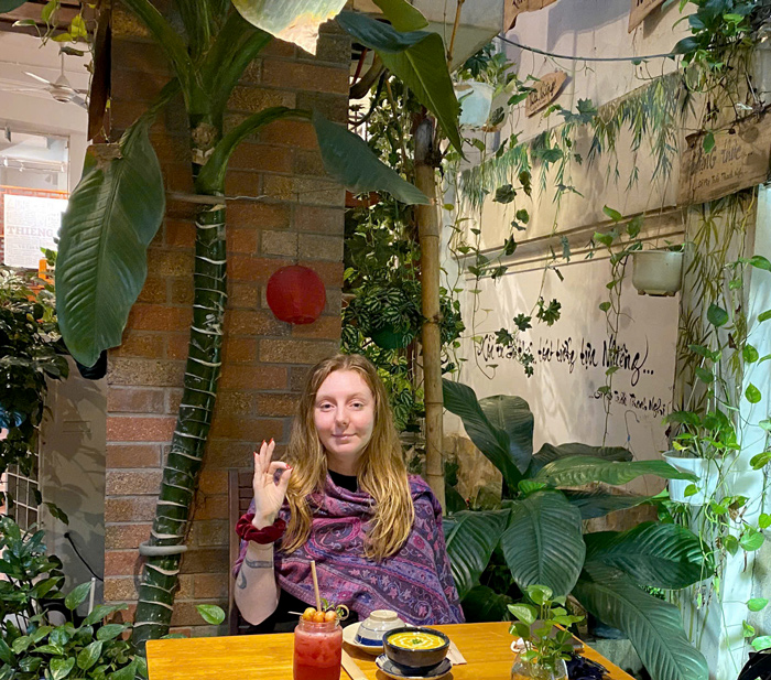 Smiling backpackers enjoying affordable vegan food Saigon