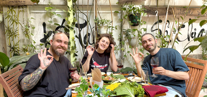 International friends enjoying vibrant vegan dishes Saigon