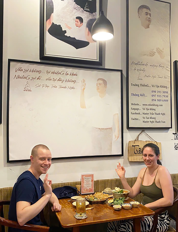 International travelers dining at a vegetarian-friendly restaurant in District 1.